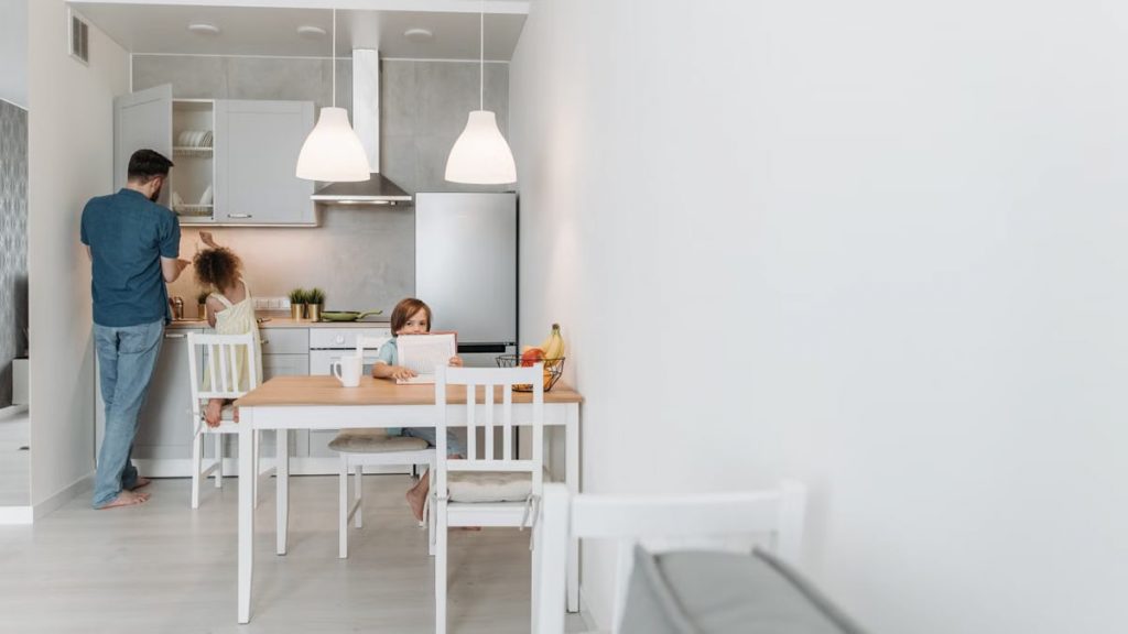 Father and children in a modern kitchen. A warm family moment captured during the day.